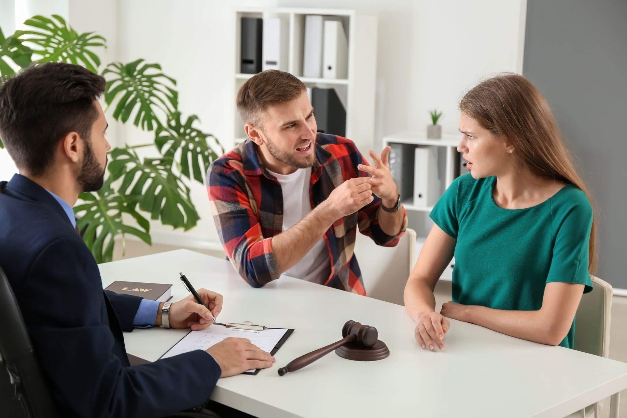 a couple of people that are sitting at a table, they seem to be arguing 
