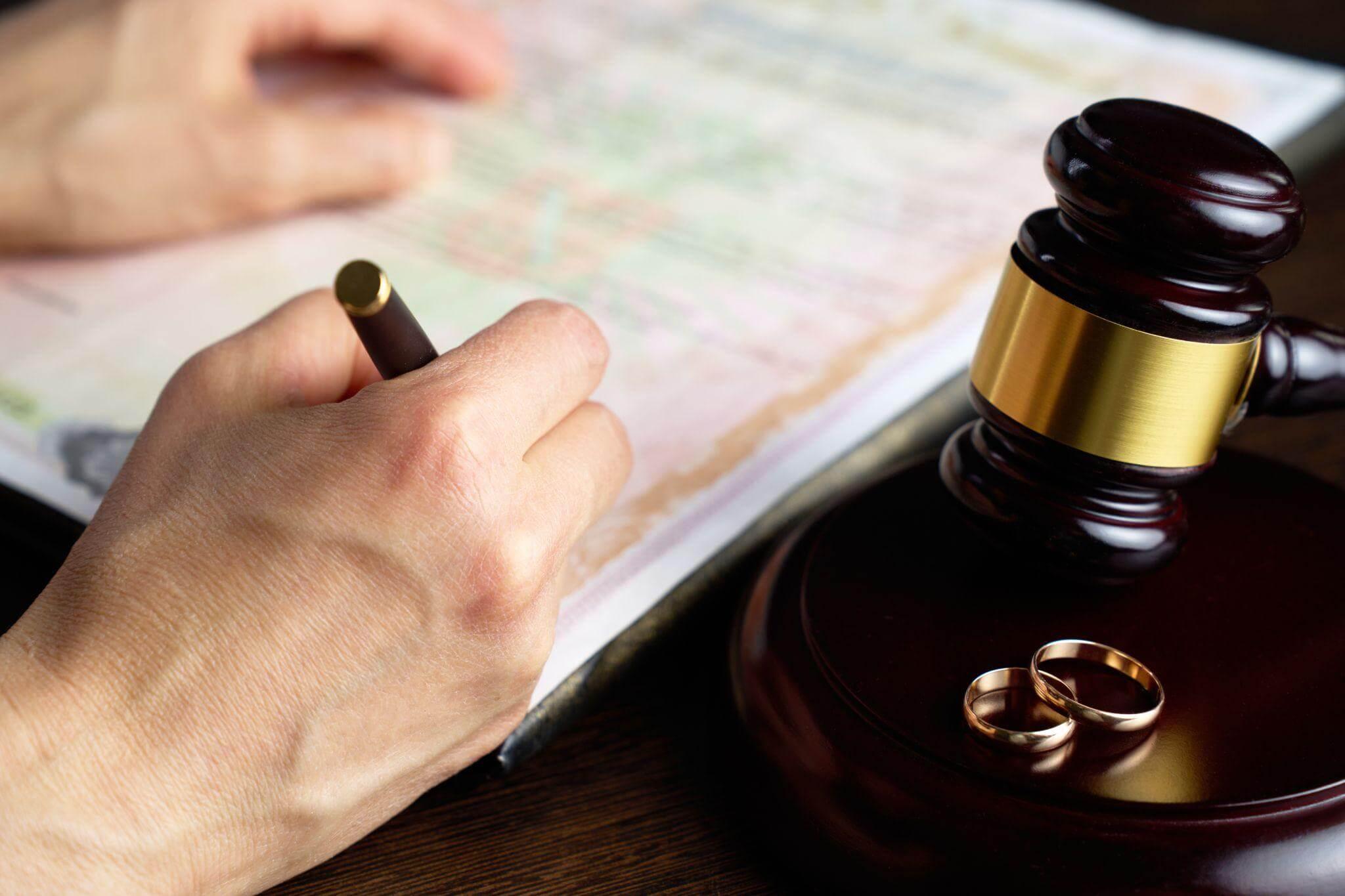 a person holding a pen in their hand next to a judge