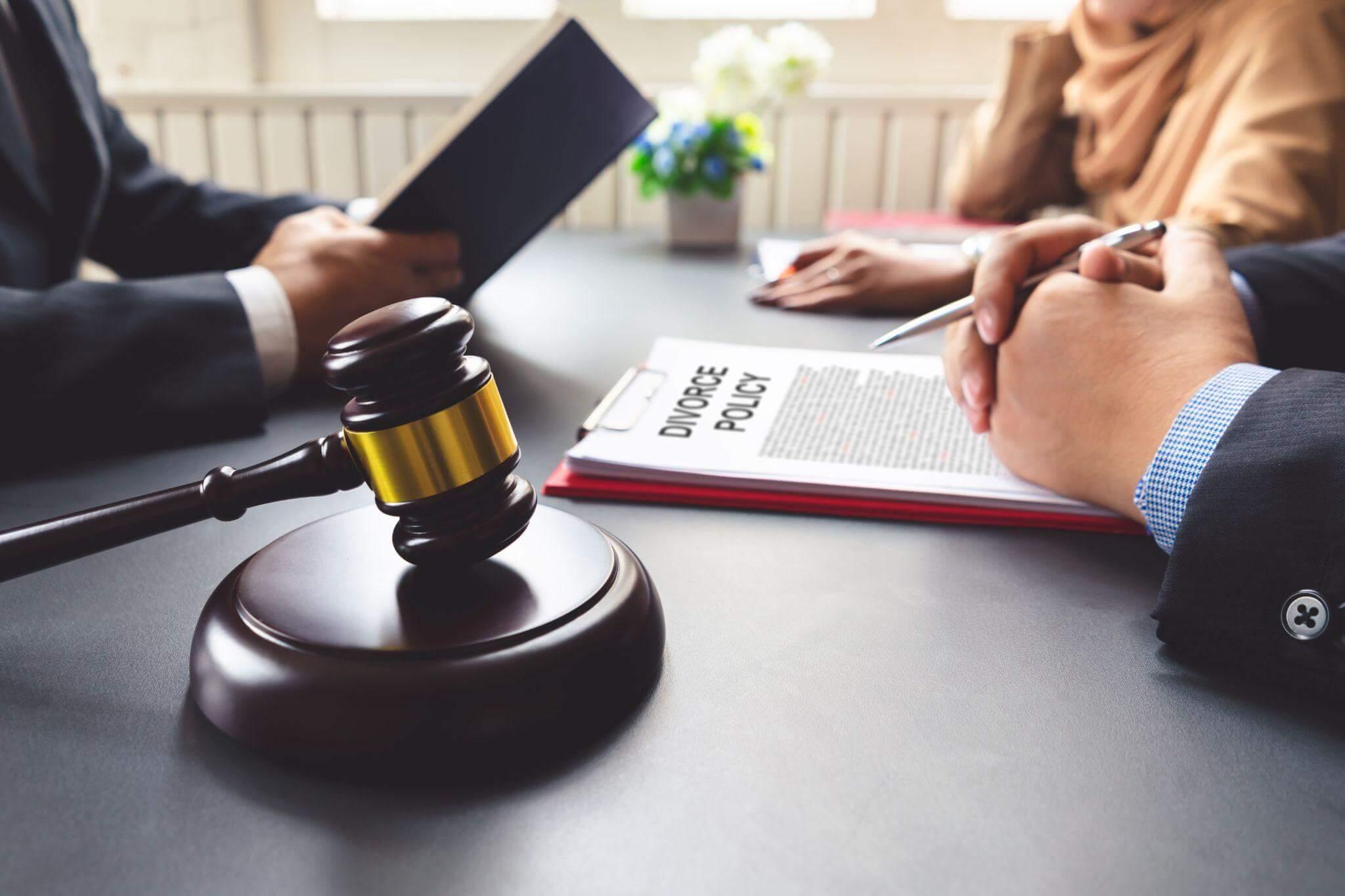 two people sitting at a table with a judge